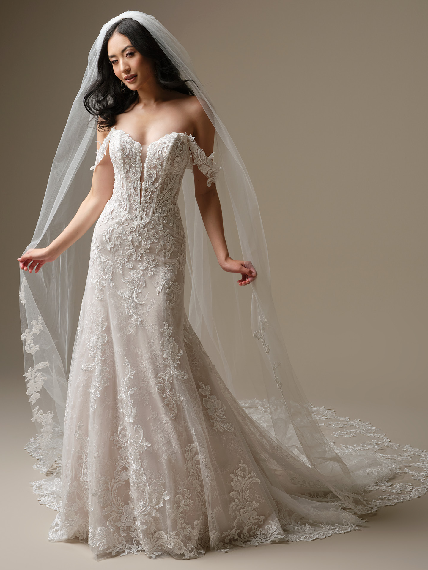 Cathedral-length bridal veil with delicate lace appliqué edging and soft sheer tulle, styled over the shoulders for a romantic, flowing look.