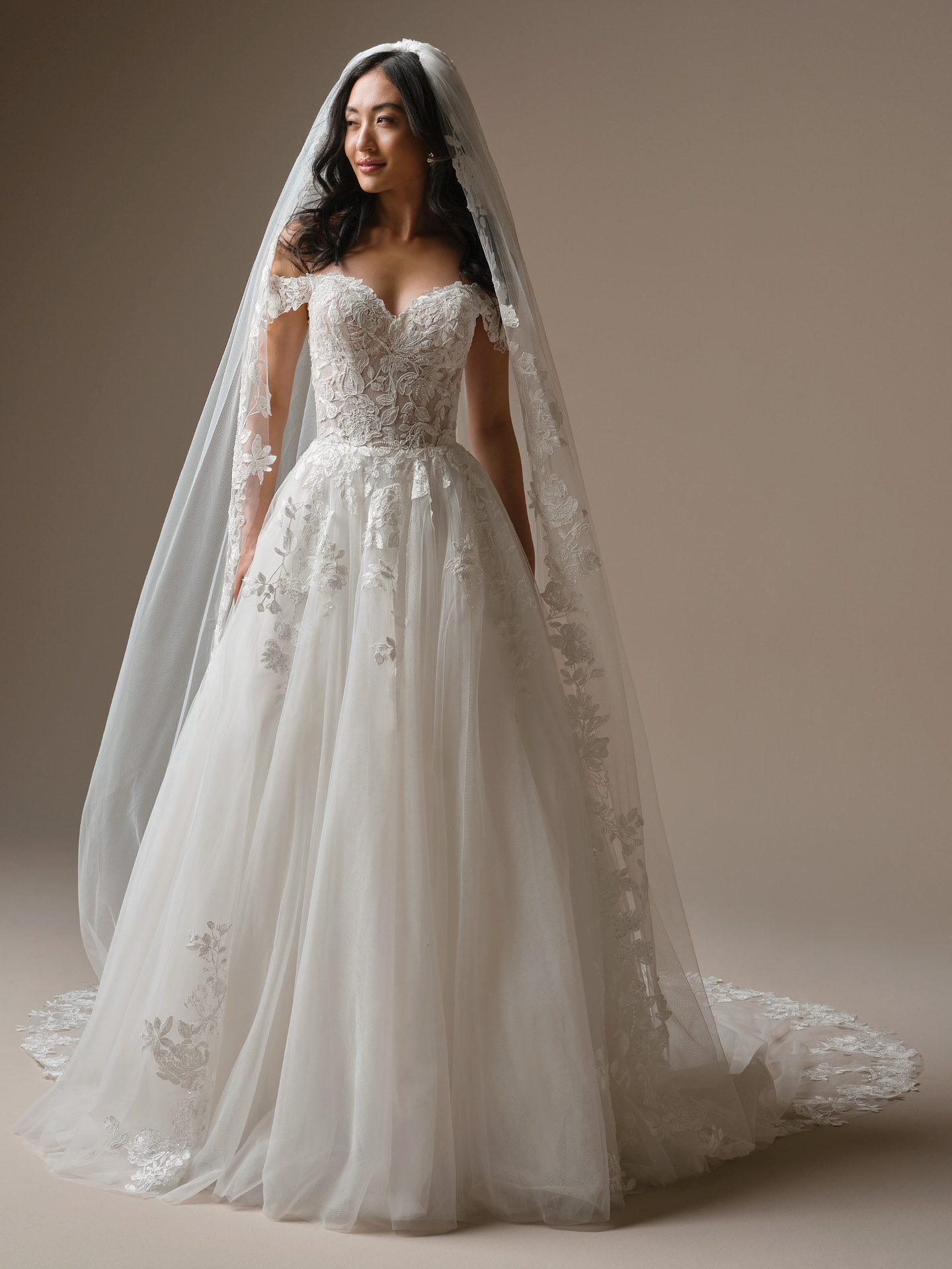 Cathedral-length bridal veil crafted in soft sheer tulle with delicate floral lace appliqué scattered throughout and detailed lace edging.