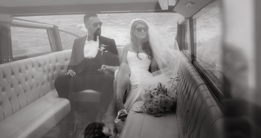 Bride wearing a wedding dress by Maggie Sottero on a boat with her husband