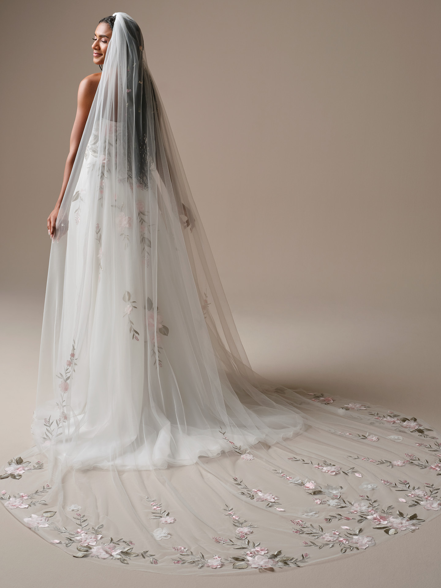 Dramatic cathedral veil featuring scattered blush floral appliqué and embroidered greenery cascading into a sweeping embroidered train.