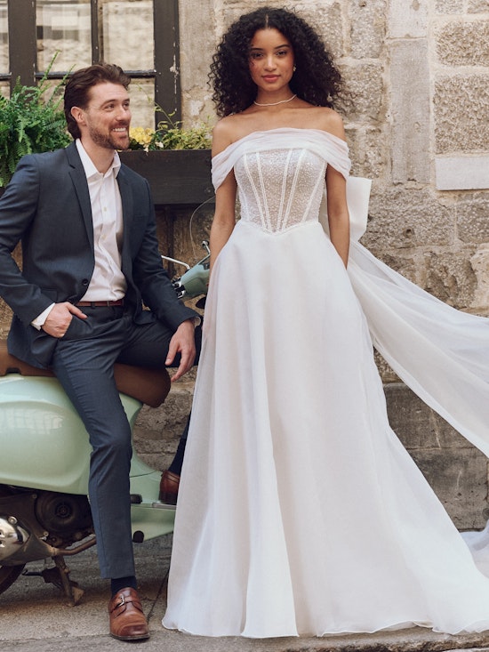 Bride wearing dress with wedding bows called Krisha by Rebecca Ingram