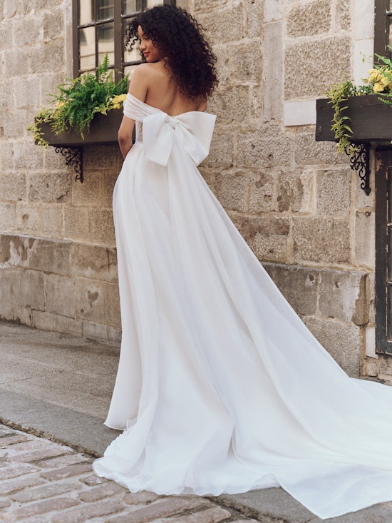 Bride wearing dress with wedding bows called Krisha by Rebecca Ingram