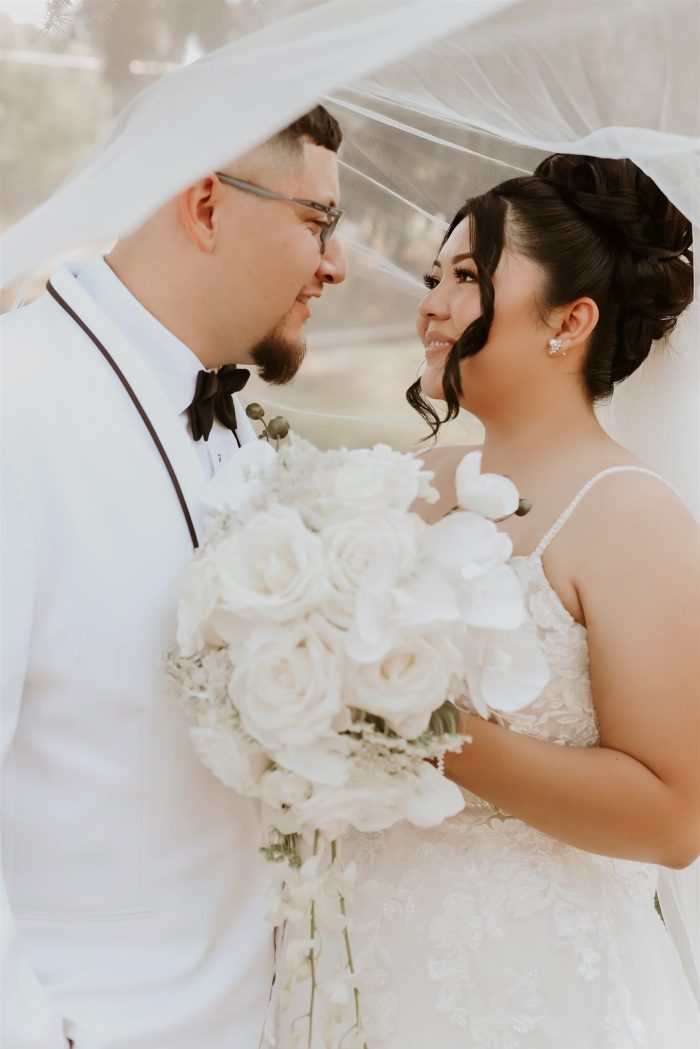 Bride wearing Stevie by Maggie Sottero with her husband under her veil