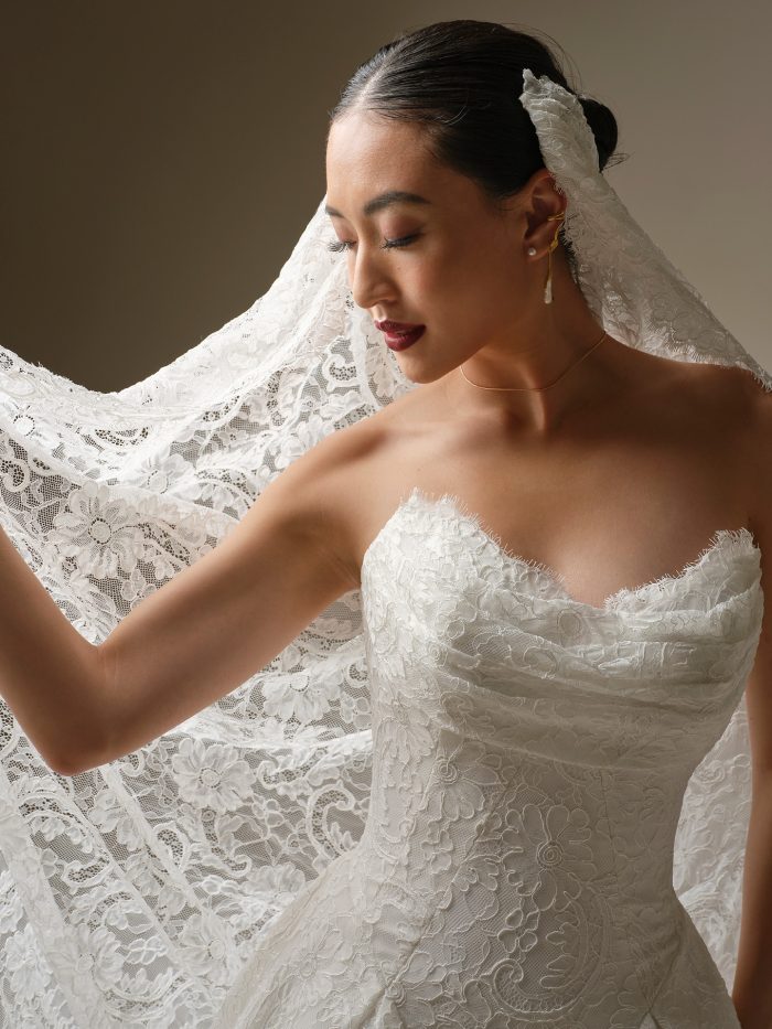 Close-up of a full lace veil with detailed floral patterning and scalloped edges for a richly textured, romantic look.