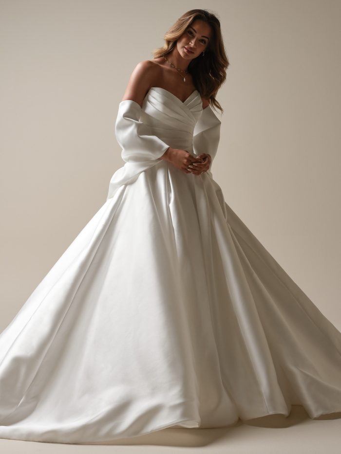 Bride in a white Mikado ballgown with arms in bow sleeves