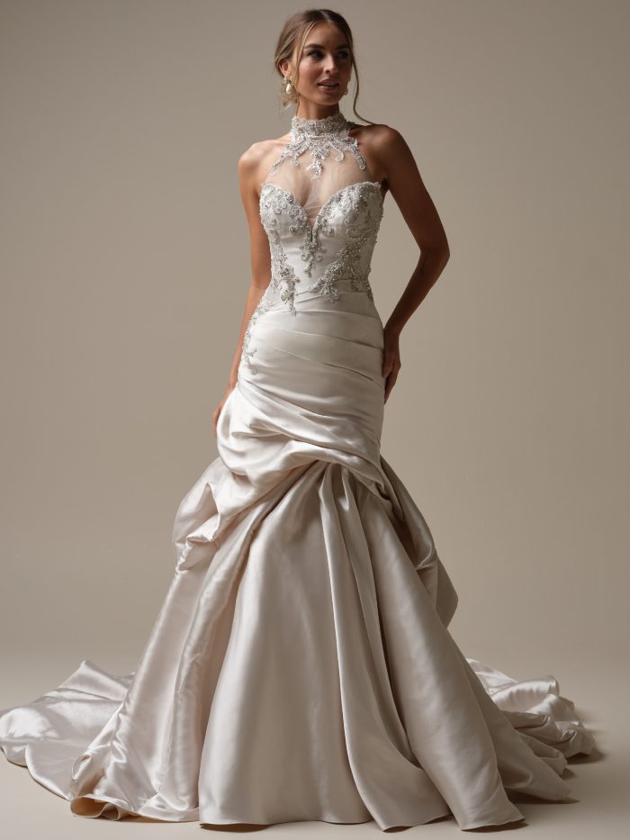 Maggie Sottero Cressida wedding dress featuring a high-neck beaded neckline, ornate embroidered bodice, and a dramatic fit-and-flare satin skirt.