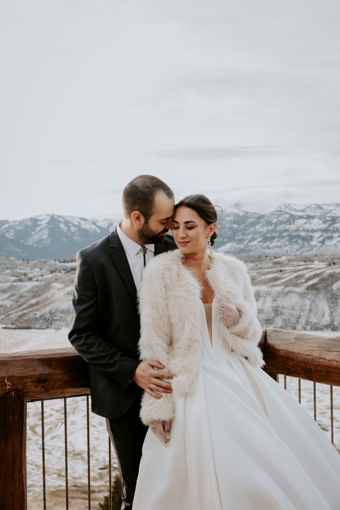 Bride wearing Fortune by Maggie Sottero with her husband outside