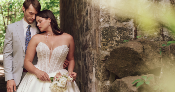 Bride wearing a drop waist wedding dress called Tina by Maggie Sottero with her husband