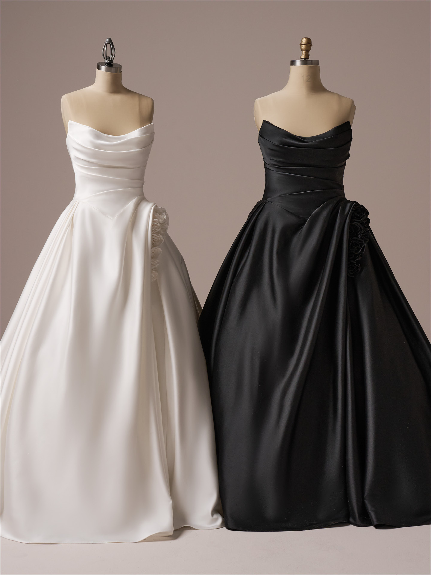 Strapless satin ballgown wedding dress shown in ivory and black with draped bodice and rosette hip detail