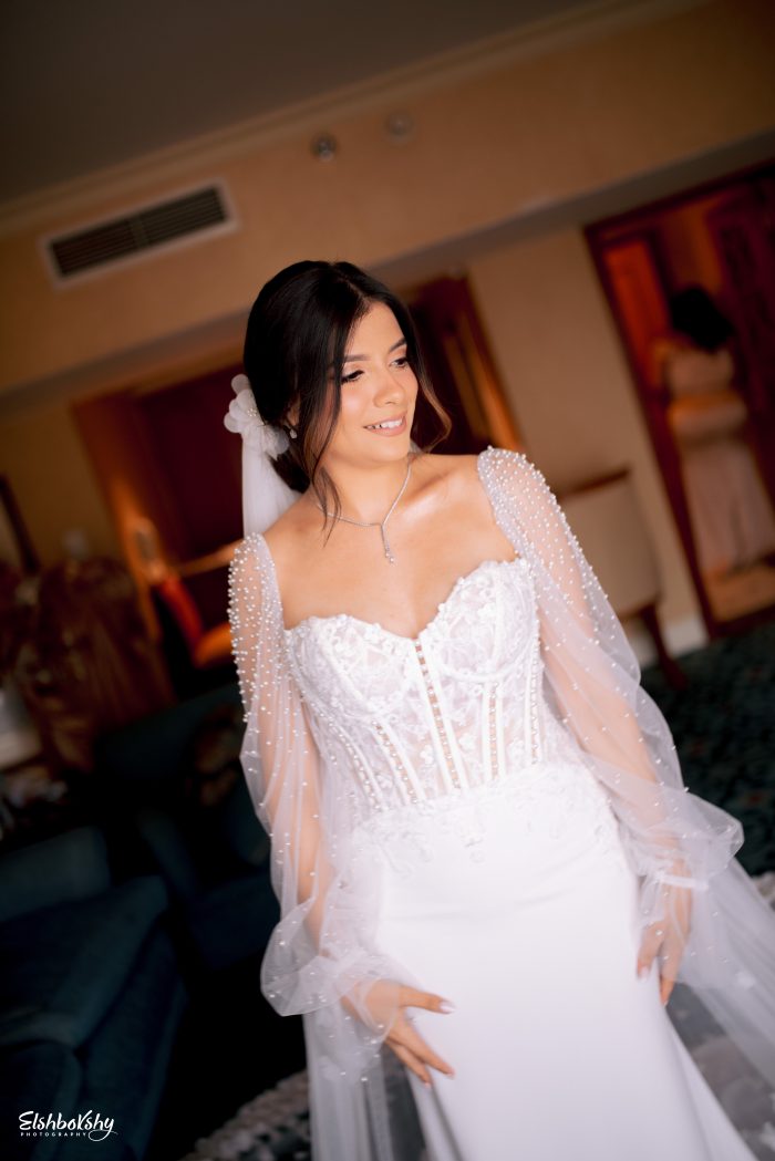 Bride wearing a sexy crepe wedding dress with pearls