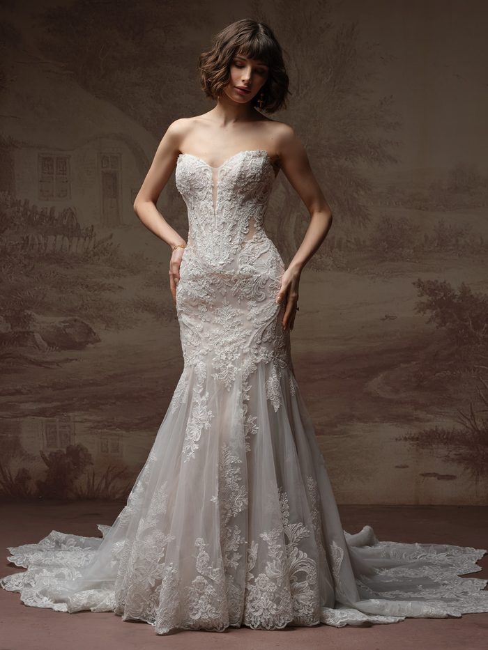 Full-length view of the Julianna fit-and-flare wedding dress by Sottero and Midgley, featuring a strapless sweetheart neckline with illusion paisley lace bodice and a fitted lace mermaid skirt flaring into a scalloped train.