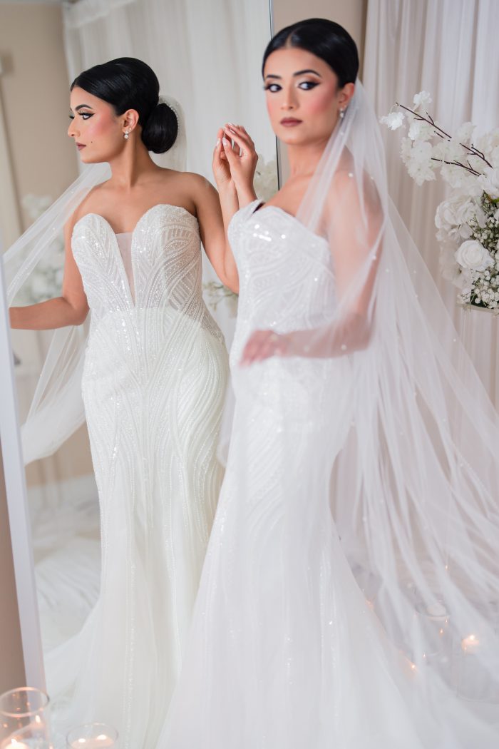 Bride wearing a fitted wedding gown with a plunge neckline