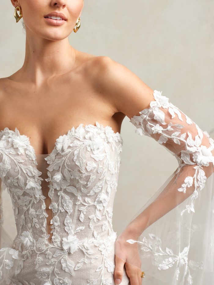 Bride wearing a wedding dress with illusion long sleeves