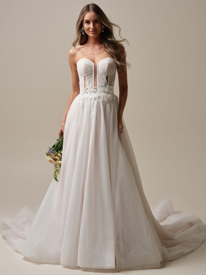 Bride in Arden, a modern ballgown wedding dress featuring a sheer corset bodice, 3D lace, and glitter tulle skirt—perfect for the Gen Z bride wanting a romantic yet bold look.