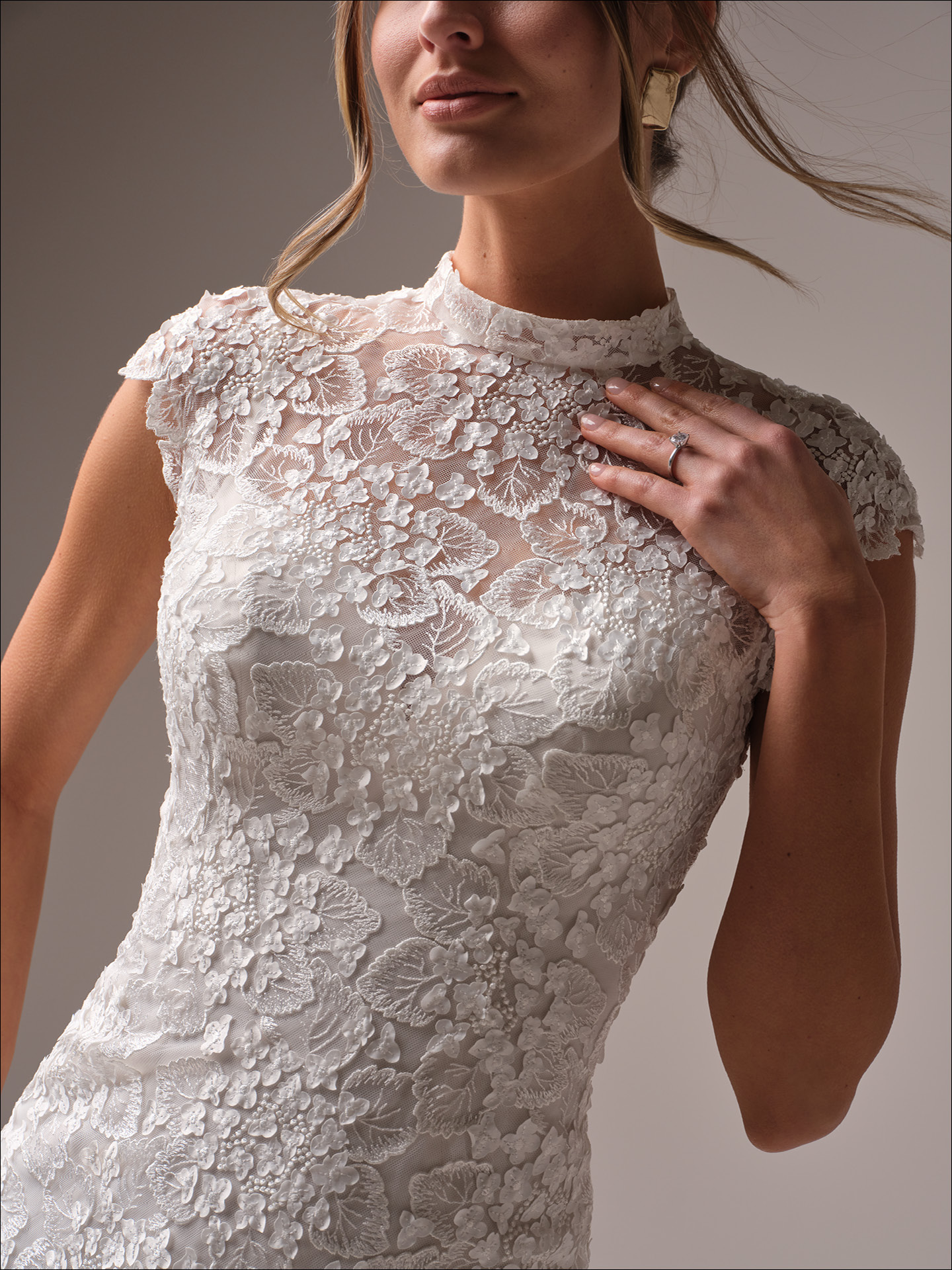 Maggie Sottero Auburn wedding dress close-up of high neck lace bodice with intricate floral appliqués and sheer detailing for a soft, romantic silhouette