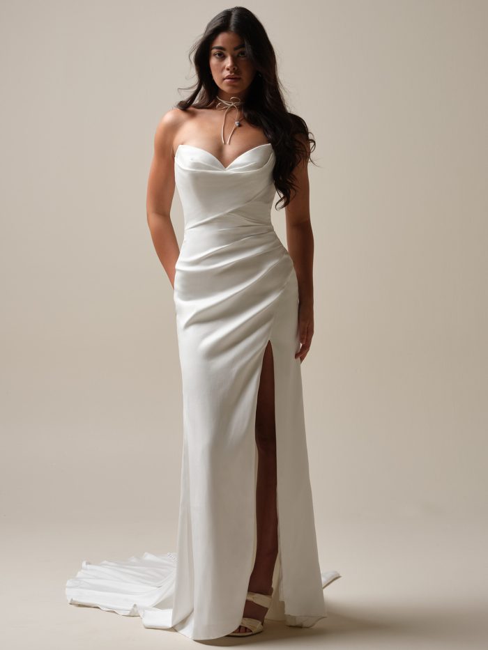 Front view of the Camille gown by Maggie Sottero with a sweetheart neckline, draped satin bodice, and side slit.