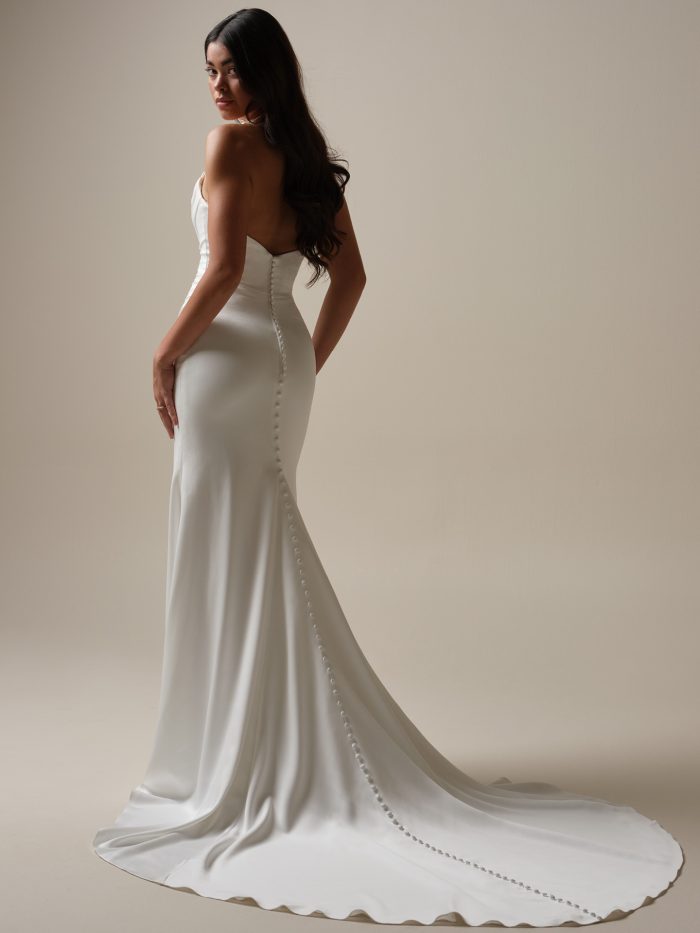Back view of the Maggie Sottero Camille sheath wedding dress featuring a row of buttons and sleek satin train.