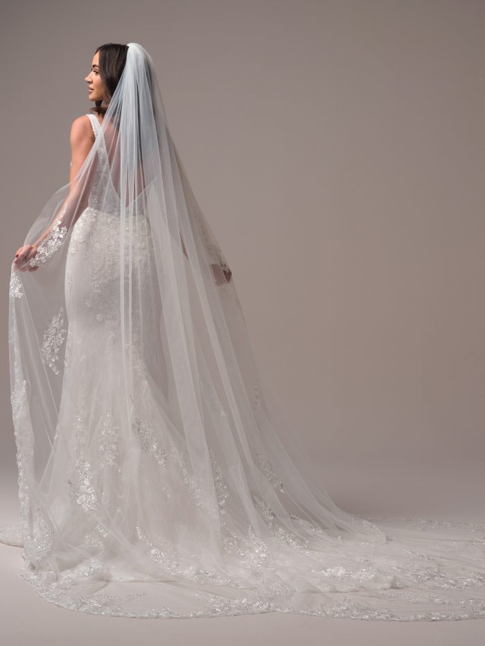 Maggie Sottero Eloise veil with delicate lace appliqués and shimmering tulle. This romantic cathedral veil offers a timeless finish, perfectly complementing classic and vintage-inspired bridal styles.