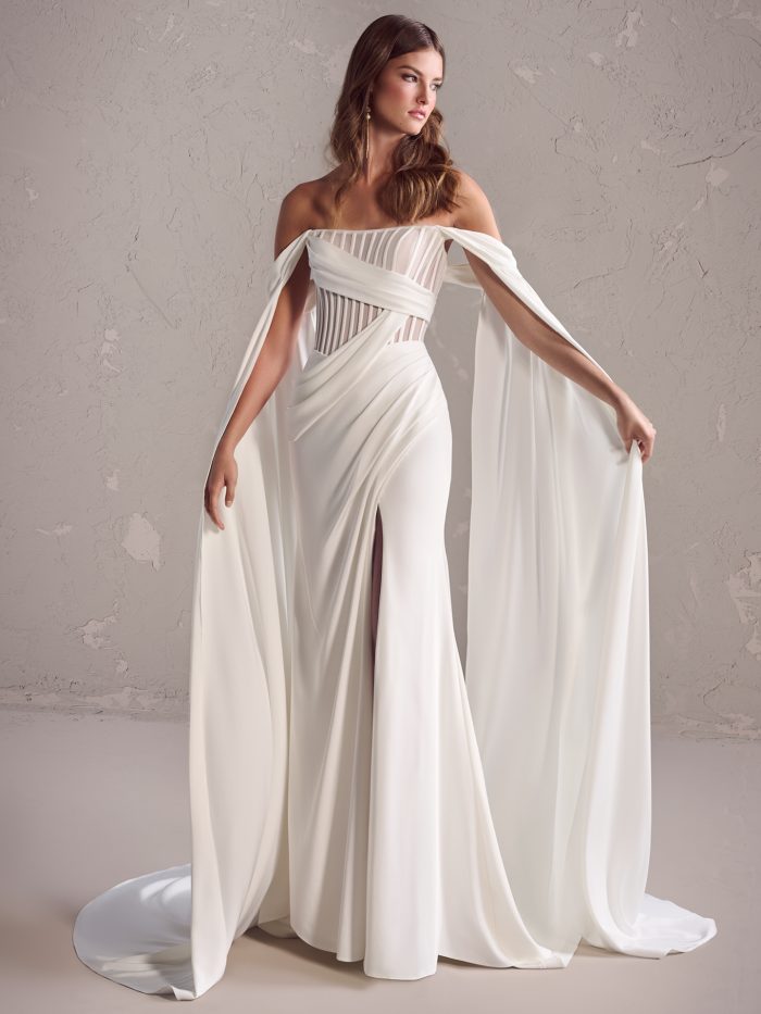 Maggie Sottero Gabrielle wedding gown with a strapless corset bodice, long chiffon sleeves, and front slit.