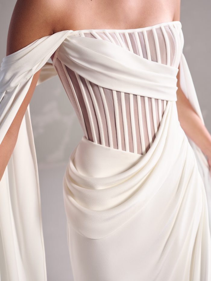 Close-up of the Maggie Sottero Gabrielle sheath wedding dress featuring a structured sheer corset bodice with draped chiffon.