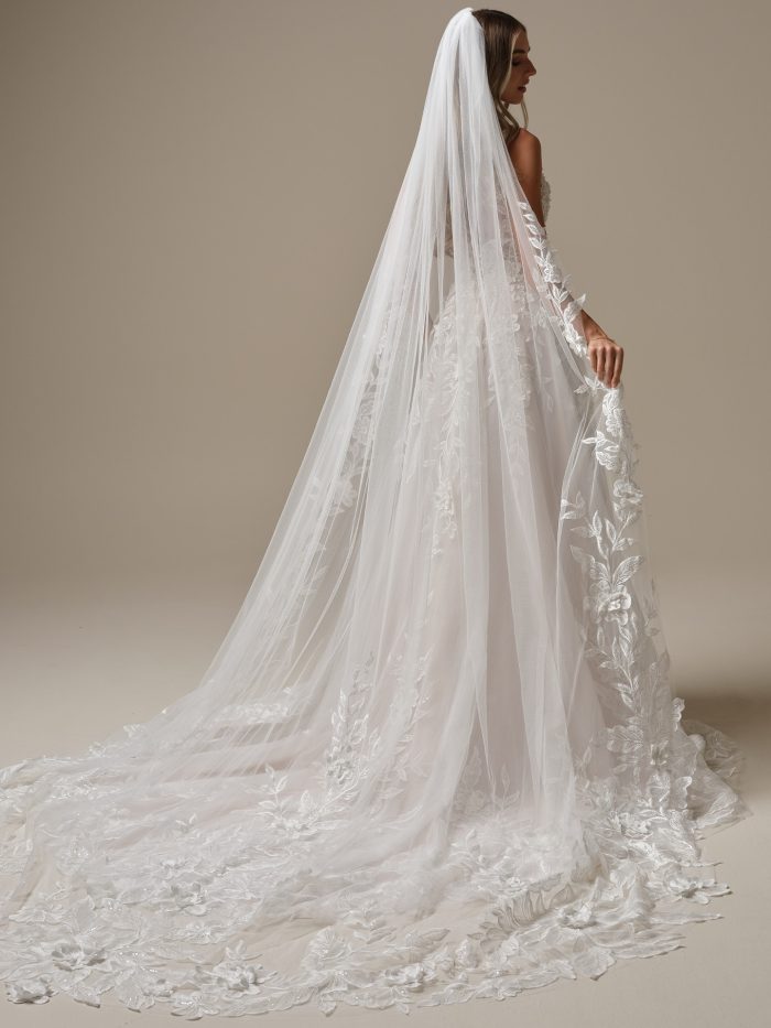  Maggie Sottero Magnolia cathedral veil featuring bold floral lace appliqués and soft illusion tulle. This romantic long bridal veil perfectly complements the Magnolia gown, adding ethereal elegance and dramatic movement to your wedding day look.