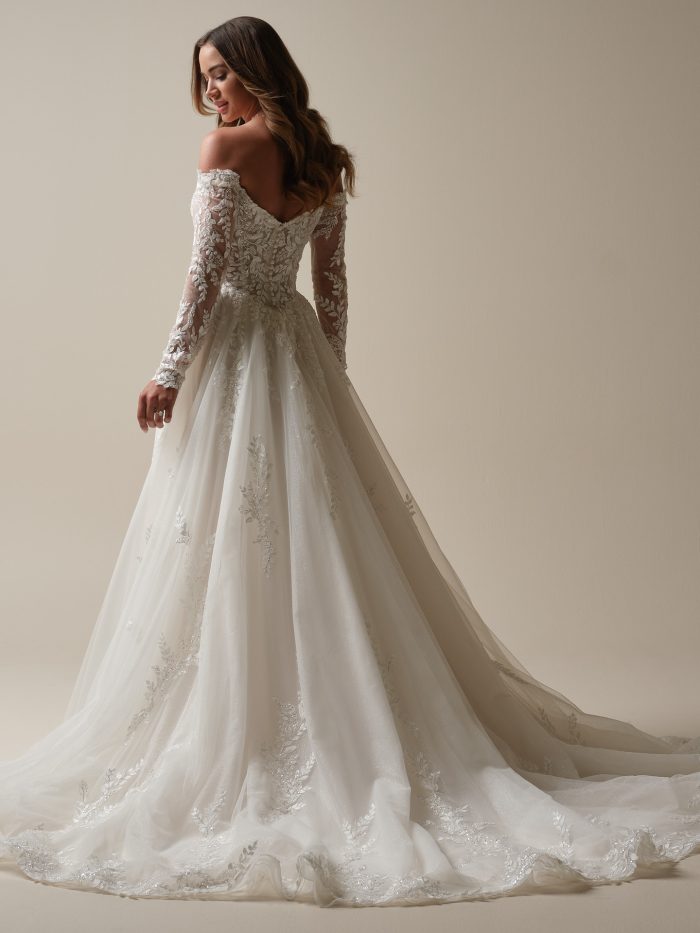 Back view of the Maggie Sottero Rita gown, a soft A-line silhouette with long lace sleeves and a chapel train—ideal for petite wedding dresses with elegant structure and movement.
