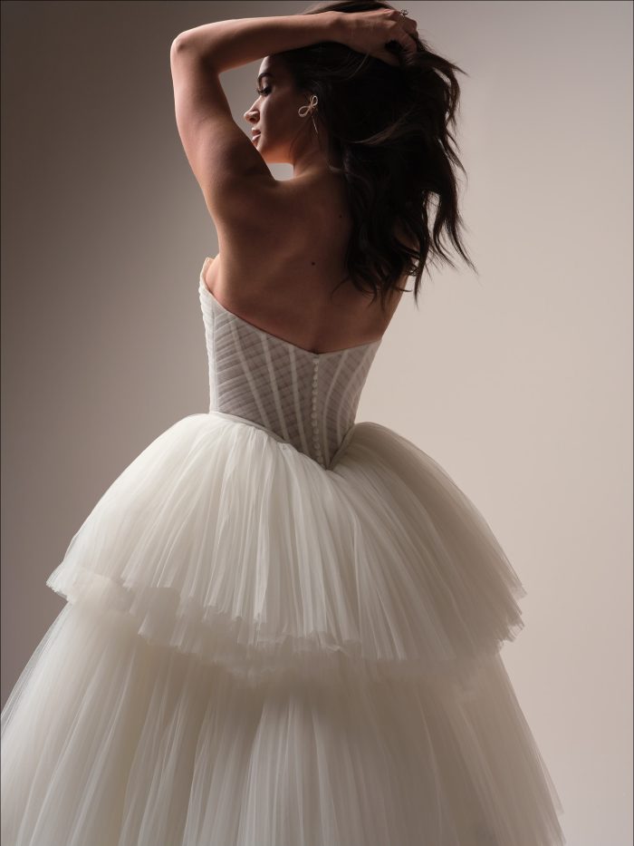 Rear view of Yurianna’s tiered tulle skirt and corset back—this ballgown wedding dress is a bold and whimsical choice for fashion-forward Gen Z brides.