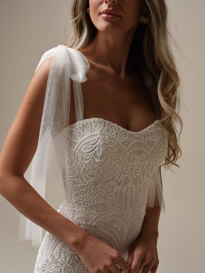 Close-up of Berkeley by Rebecca Ingram lace wedding dress bodice with sweetheart neckline and soft tulle shoulder ties.