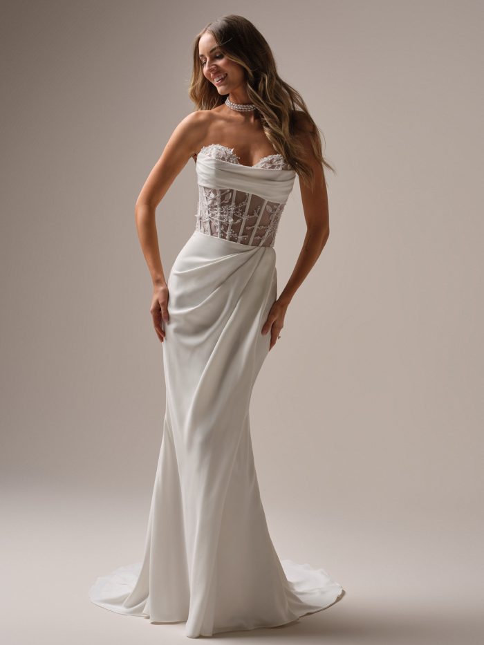Bree by Rebecca Ingram corset lace and crepe sheath wedding dress with sweetheart neckline, illusion beaded lace bodice, and draped skirt.