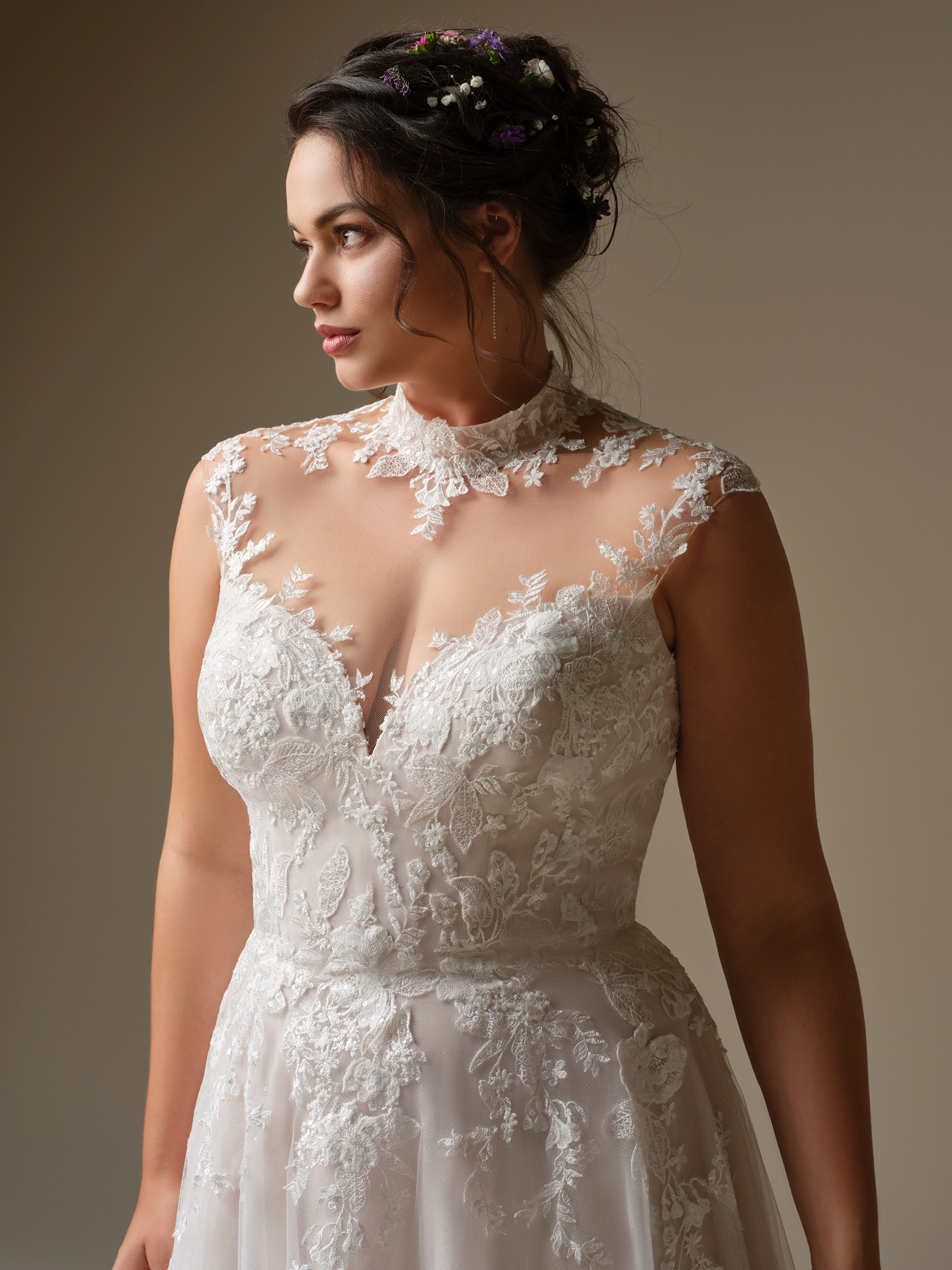 Rebecca Ingram Cody wedding dress close-up of illusion high neck lace bodice with delicate floral appliqués and sheer neckline, creating a feminine and ethereal silhouette