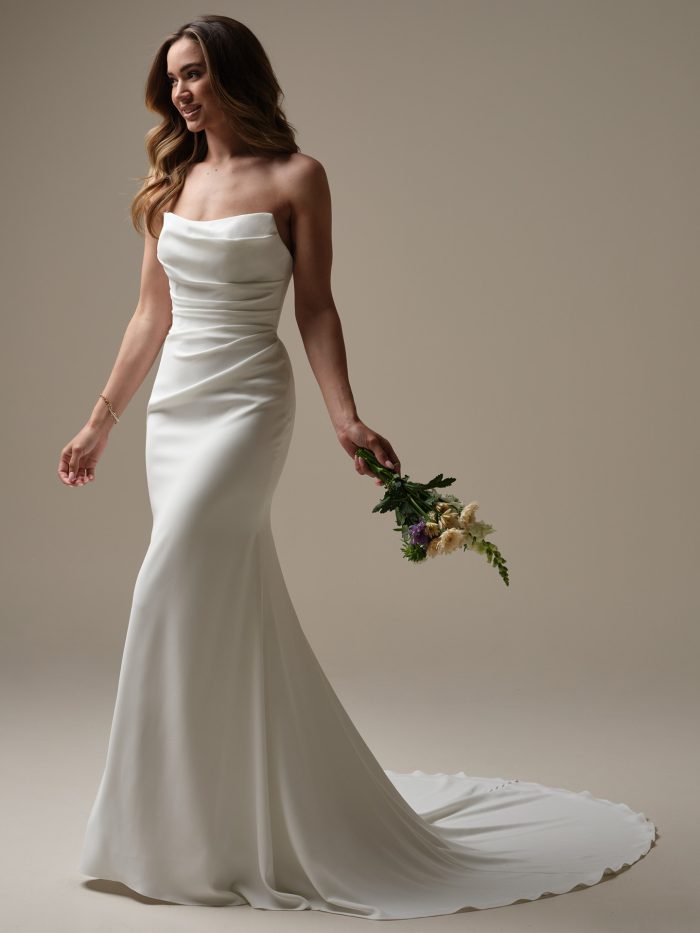 Rebecca Ingram Denise sheath wedding dress with a strapless neckline and sleek satin silhouette.
