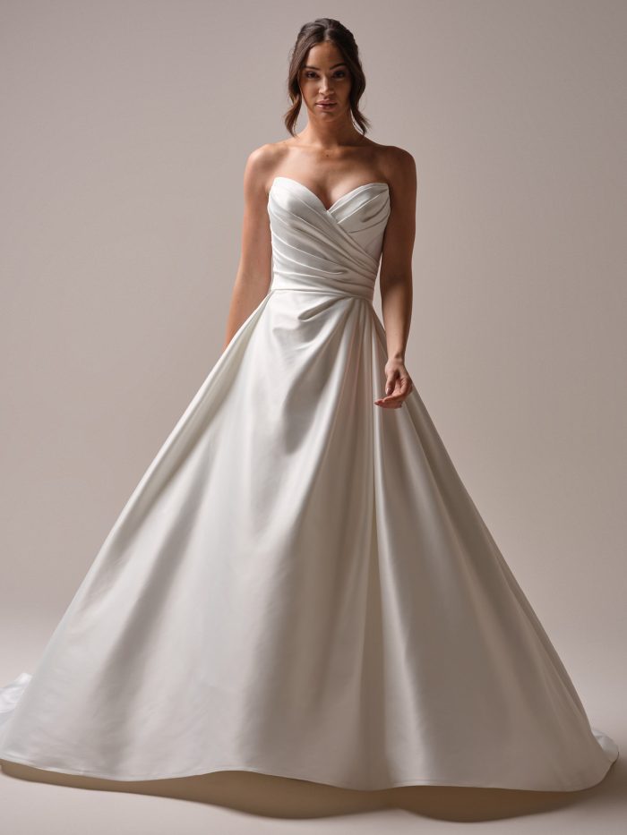 Bride wears Hannah by Rebecca Ingram—a strapless satin ballgown with a pleated bodice, sweetheart neckline, and full A-line skirt; a clean and modern silhouette with timeless charm.