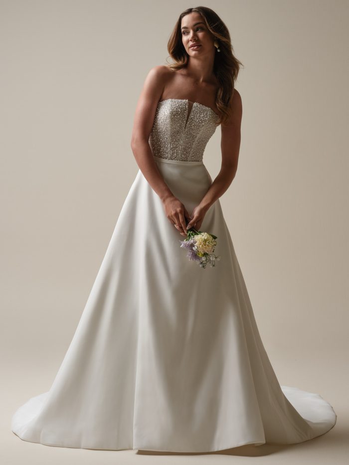 A-line wedding dress featuring a fully beaded illusion bodice with spaghetti straps, a sweetheart neckline, and a soft tulle skirt with a high slit. The beading includes pearl and sequin accents for a sparkly, dimensional effect.