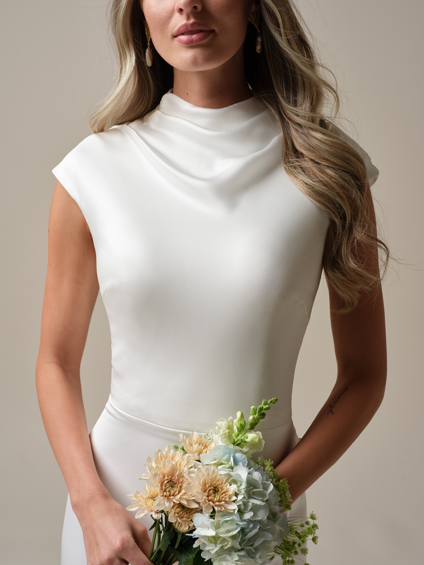 Rebecca Ingram Jett Leigh wedding dress close-up of soft cowl neckline and clean crepe bodice, highlighting elegant draping and a timeless, refined bridal look
