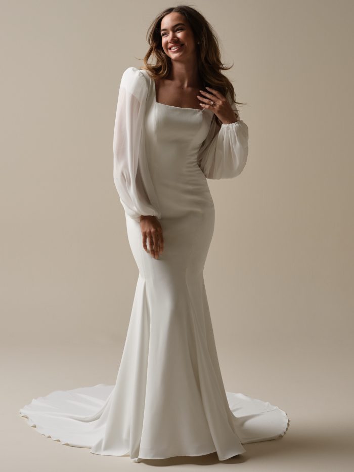 Bride in Jorie, a sleek modern wedding gown with puff chiffon sleeves, square neckline, and a fitted silhouette—this trending bridal style is simple, chic, and totally Gen Z–approved.