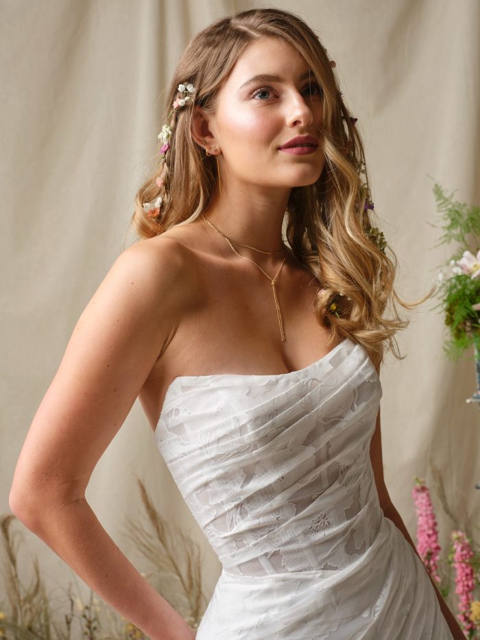 Close-up of Kendall by Rebecca Ingram strapless boho wedding dress with ruched printed organza bodice and soft floral pattern.