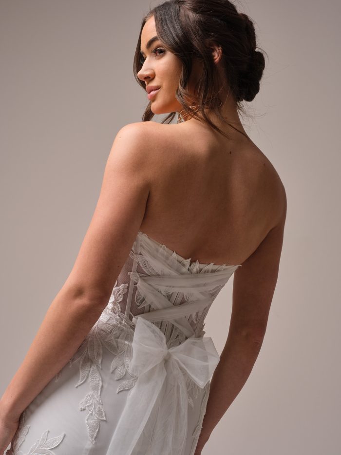 Close-up of Belladonna’s lace-up back and oversized tulle bow—elegant and edgy details for the modern Gen Z bridal vibe.
