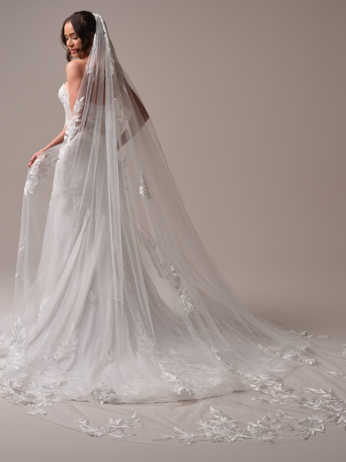 Sottero and Midgley Belladonna veil in cathedral length, featuring bold leafy lace appliqués and soft sheer tulle. This dramatic long veil adds modern romance and elevated detail to any bridal look.