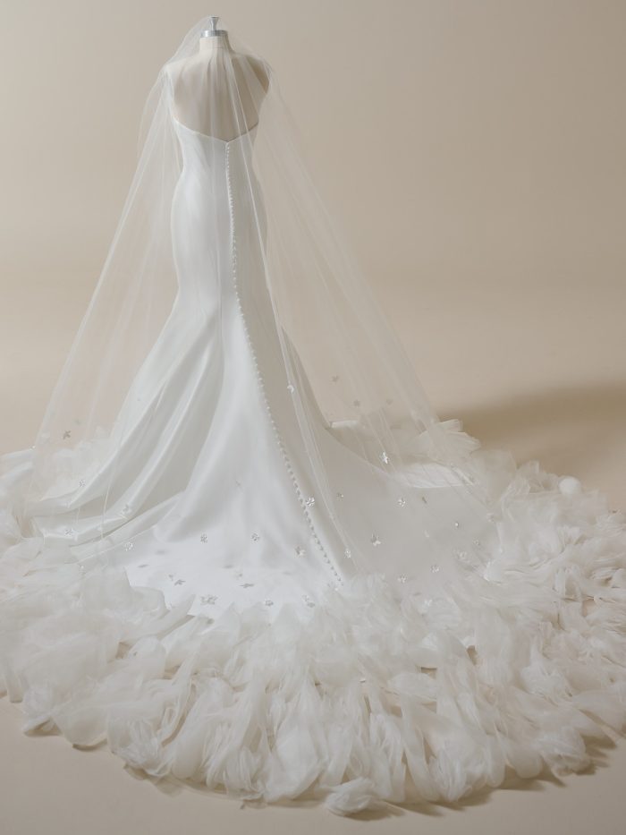 Sottero and Midgley cathedral veil featuring sheer tulle and scattered floral appliqués. This lightweight bridal veil adds subtle detail and soft romance to modern and minimalist wedding gowns.