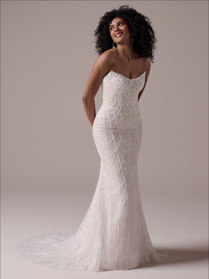  Gen Z bride in Constance, a sheath wedding dress with vintage-inspired beadwork, sheer pearl bodice, and detachable straps—effortlessly elegant with a modern twist.