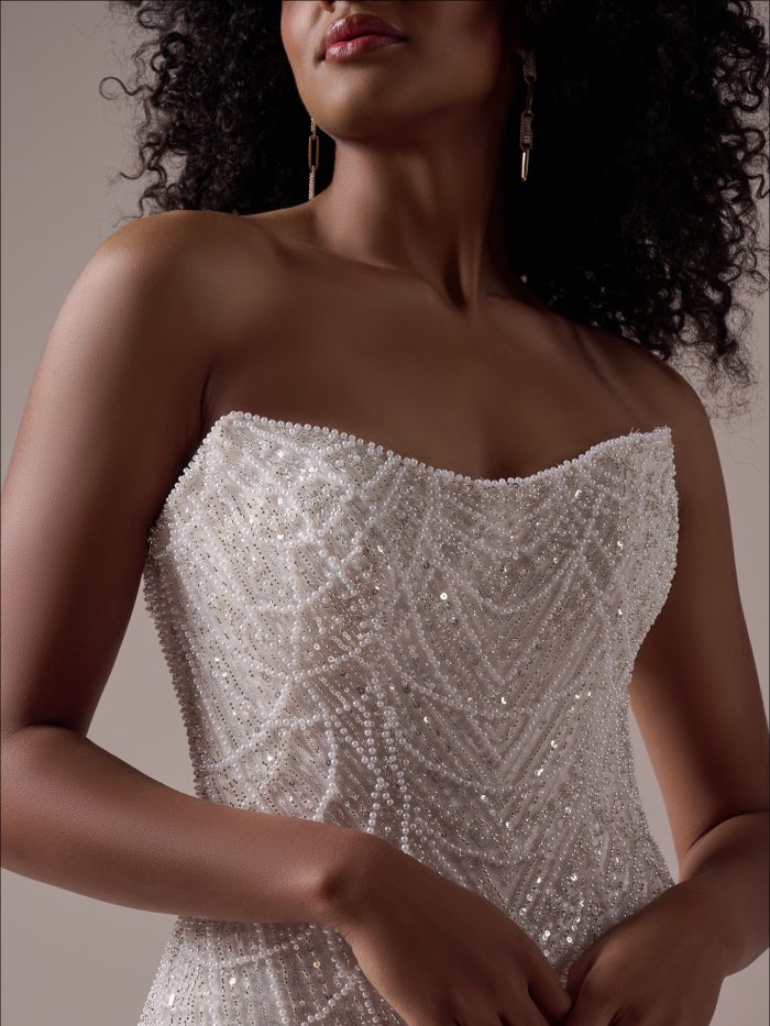 Close-up of Constance wedding gown showing hand-beaded detail and sheer neckline—perfect for the Gen Z bride embracing glam bridal style.