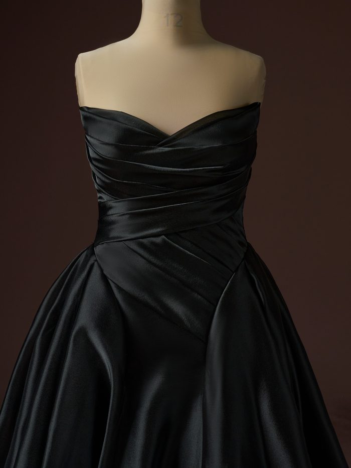 Bodice detail of the Rosamund A-line wedding dress by Maggie Sottero, highlighting a strapless sweetheart neckline with elegant ruched satin and softly structured draping at the waist.