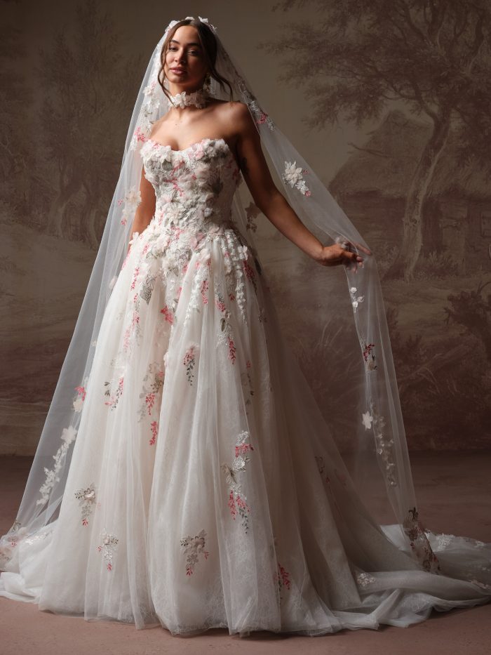 Maggie Sottero Benton ballgown wedding dress with pink floral embroidery and matching Benton cathedral veil