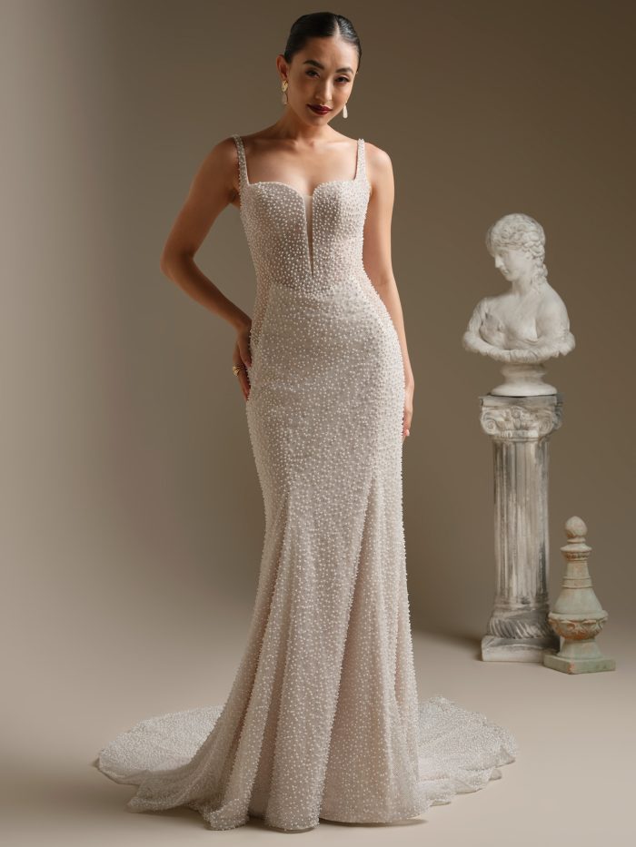 Alt text: “Front view of Sottero and Midgley Cooper sheath wedding dress adorned with allover pearl beading, featuring a square neckline, illusion plunge, and elegant sweep train.”