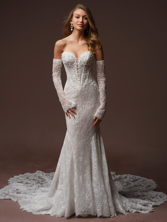 Front view of a bride wearing the Bellevue Royale fit-and-flare wedding dress with off-the-shoulder detachable lace sleeves, a sweetheart neckline with sheer illusion bodice, and a fitted lace skirt flaring into a train.
