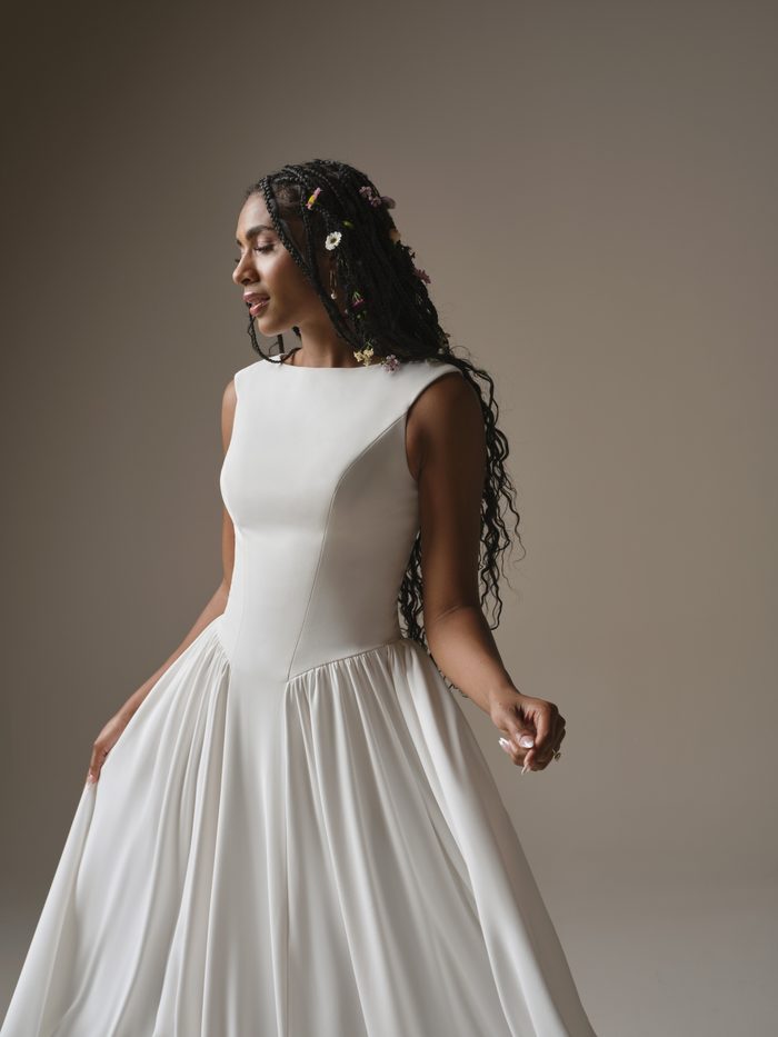 Rebecca Ingram Shay A-line wedding dress with a bateau neckline, fitted bodice, and soft flowing skirt for a lengthening silhouette.