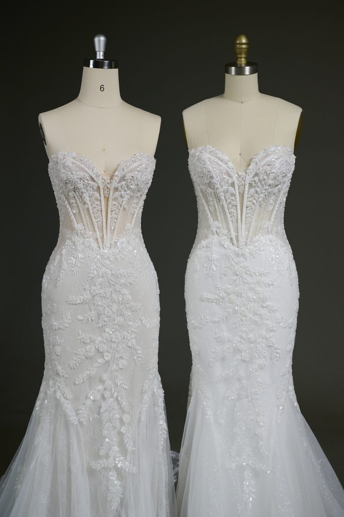 Two versions of the Benjie Royale by Maggie Sottero wedding gown are displayed side by side on dress forms. Both feature a fitted silhouette, a sheer corset bodice with exposed boning, and intricate lace appliqués with beaded embellishments. The gown on the left features a plain tulle skirt layer for a softer, matte finish, while the gown on the right incorporates glitter tulle beneath the lace, adding subtle shimmer throughout the skirt and train.