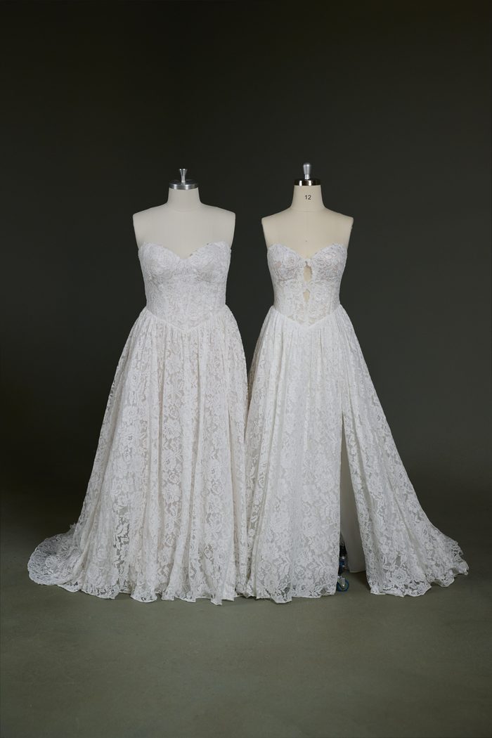 Two versions of the Narelle by Rebecca Ingram wedding gown are displayed side by side on dress forms. Both feature a strapless sweetheart neckline, allover floral lace, and an A-line silhouette. The gown on the left showcases a fully closed lace bodice and skirt, while the gown on the right features a front bodice keyhole cutout and a dramatic thigh-high slit, highlighting customizable design options.