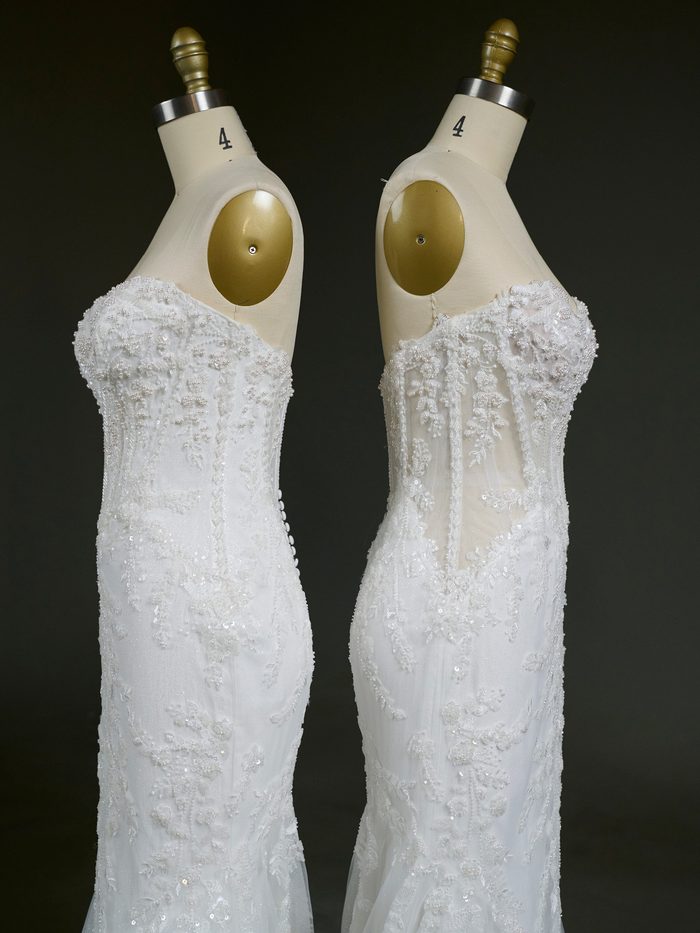 Side-profile comparison of two versions of the Benjie Royale by Maggie Sottero wedding gown displayed on dress forms. Both gowns feature a fitted silhouette with sparkling lace appliqués, beaded embellishments, and a sweetheart neckline. The gown on the left has a fully lined corset bodice that creates a more seamless, opaque look, while the gown on the right features a sheer bodice with visible boning and transparent side panels that emphasize the gown’s corset construction and lace detailing.