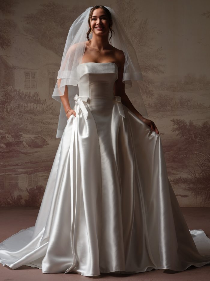 Bellissima by Maggie Sottero veil from the Essentials Edit, showcasing a soft fingertip-length tulle veil with clean edge detail, styled with a strapless satin ball gown..